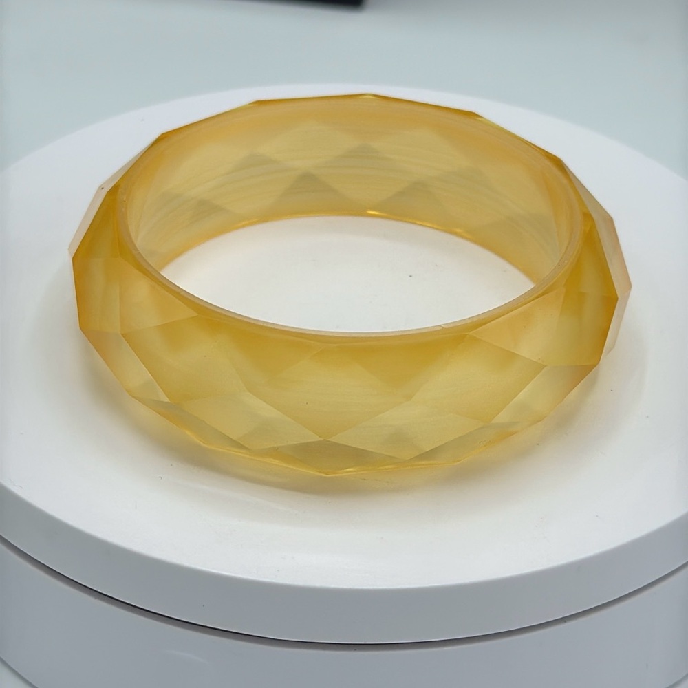 Facet cut yellow lucite bangle.  Size 7.75-8.5​